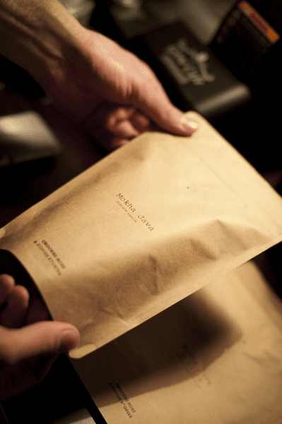 Kraft compostable packaging held in hand
